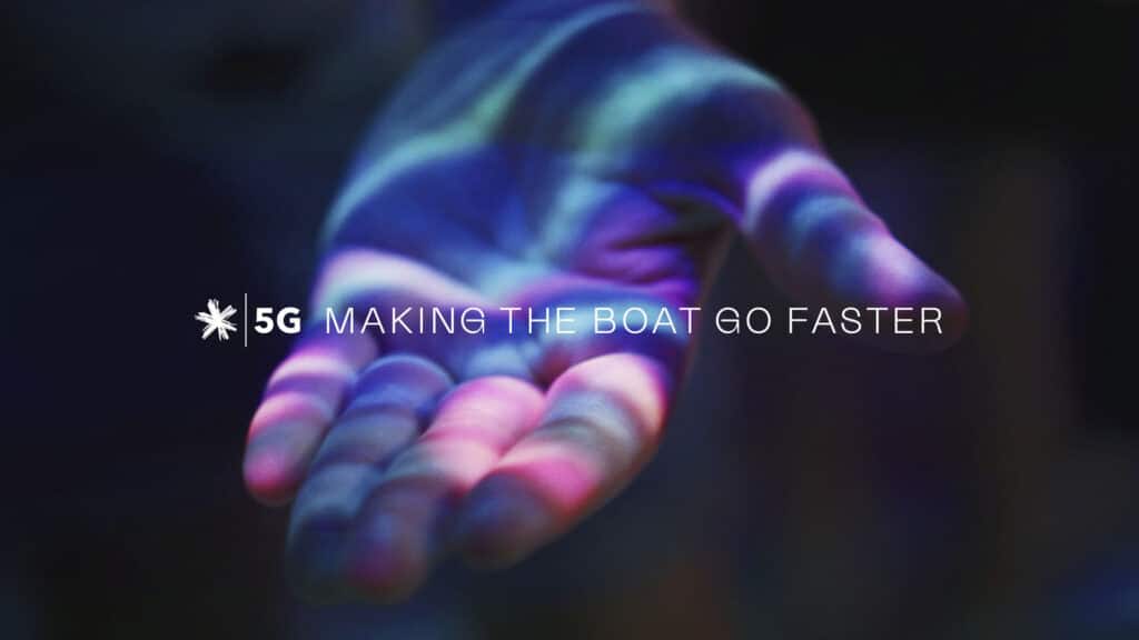 A photograph of a hand facing palm upwards. Text is overlayed on top that says "5G Making the boat go faster" as well as the Spark logo
