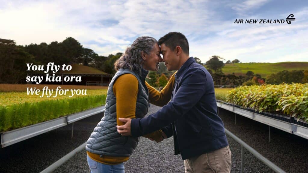 A photo of two people performing a hongi. The text "You fly to say kia ora. We fly for you" is overlayed on top as well as the Air New Zealand logo.
