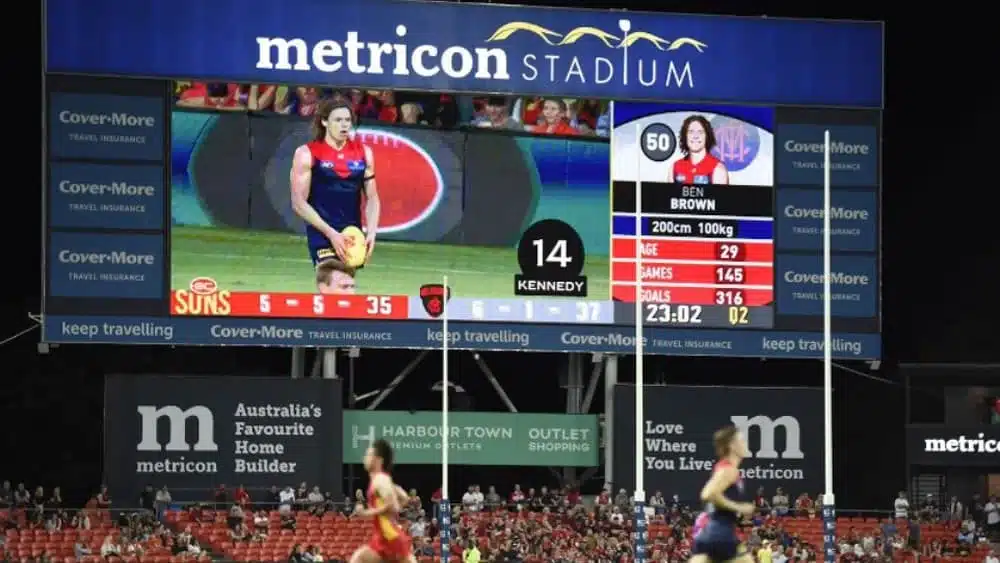 A photograph of a football game at Metricon Stadium