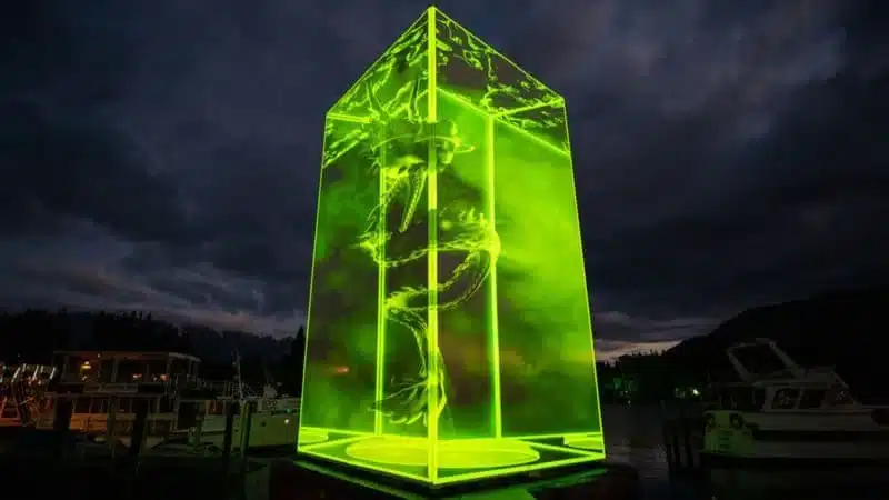 An image of a sculptural installation featuring a large green translucent cube